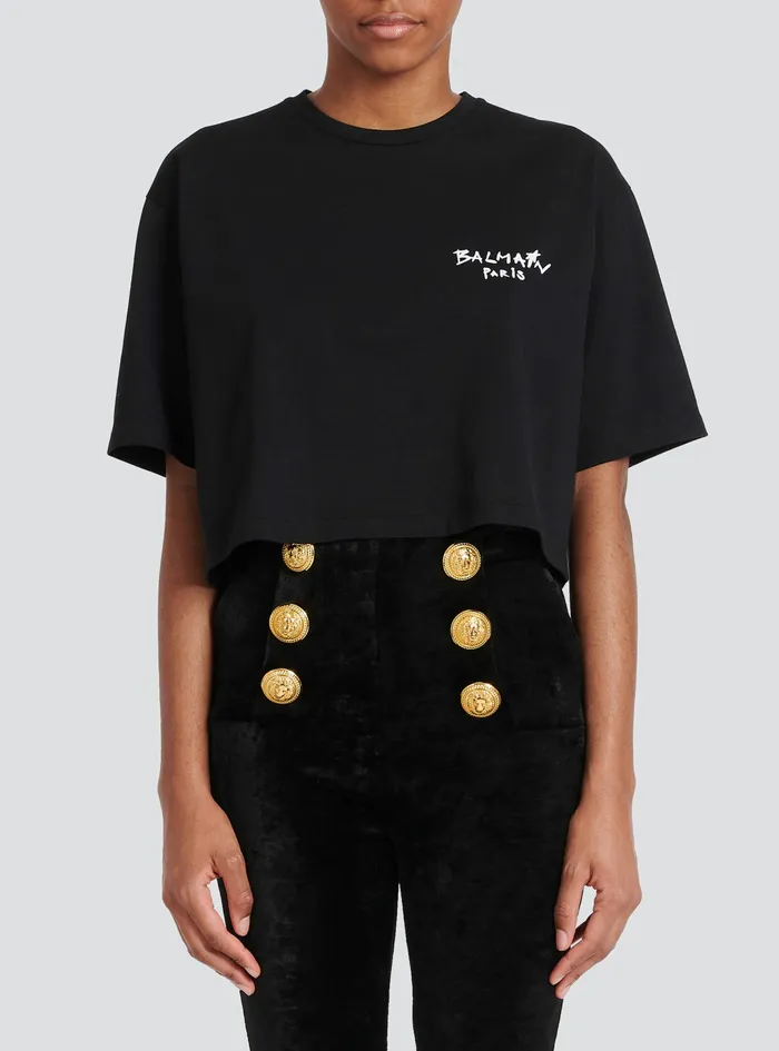 Balmain TShirts Womens Cropped Cotton TShirt With Small Flocked Graffiti Balmain Logo Black Balmain TShirts Womens Cropped Cotton TShirt With Small Flocked Graffiti Balmain Logo Black