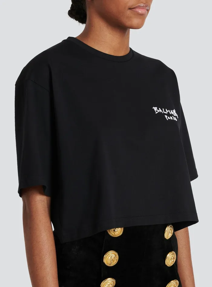 Balmain TShirts Womens Cropped Cotton TShirt With Small Flocked Graffiti Balmain Logo Black Balmain TShirts Womens Cropped Cotton TShirt With Small Flocked Graffiti Balmain Logo Black